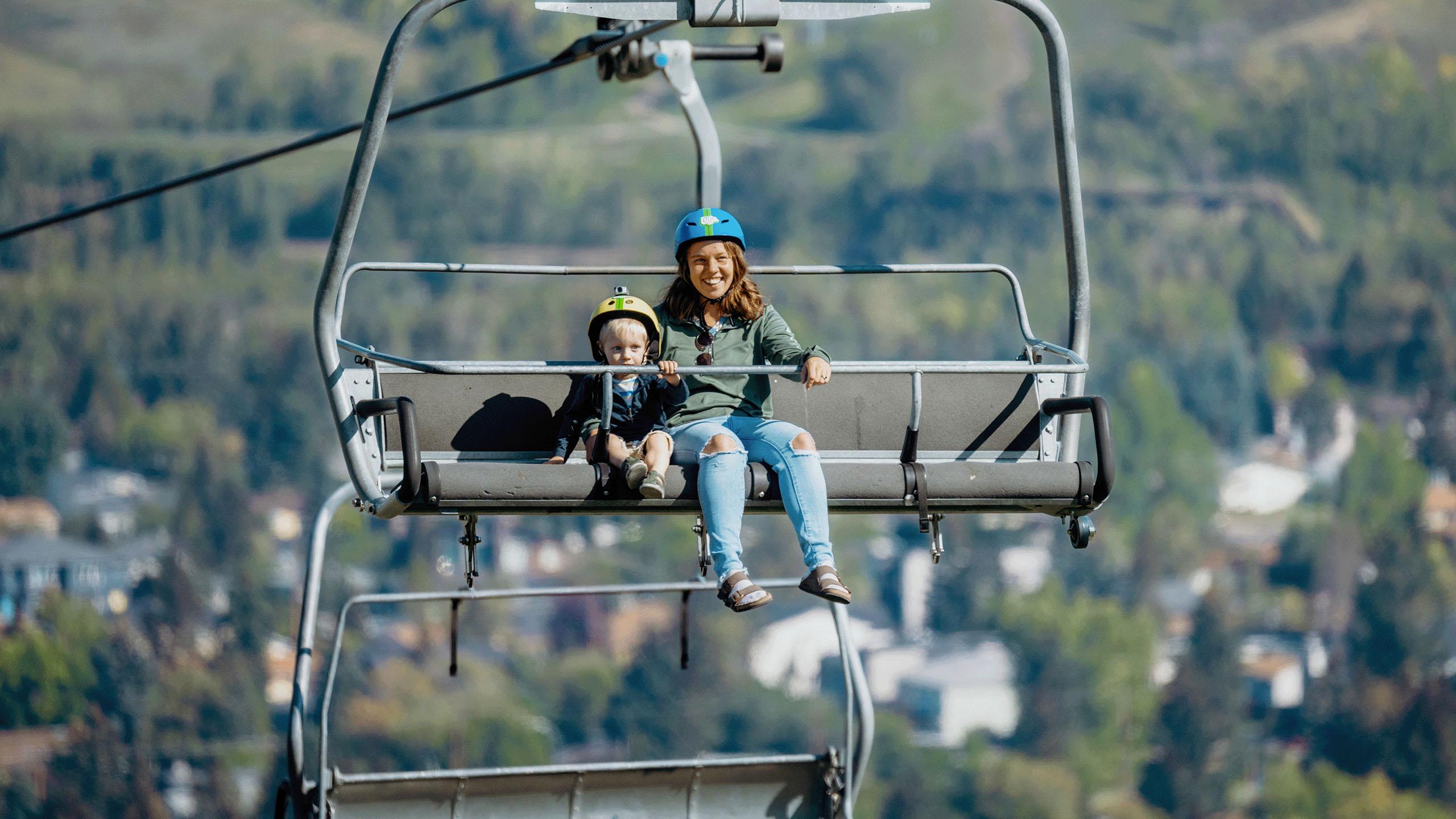A mother and her son ride the chairlift to the top of the tracks at Downhill Karting Calgary.