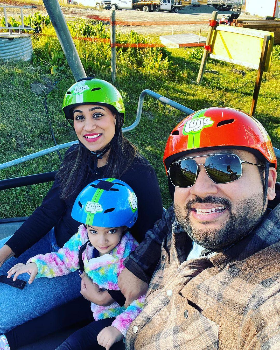 A family rides the Downhill Karting Calgary chairlift together.