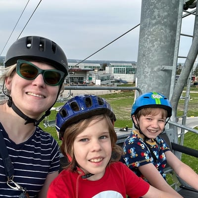 A family rides the Downhill Karting Calgary chairlift together.