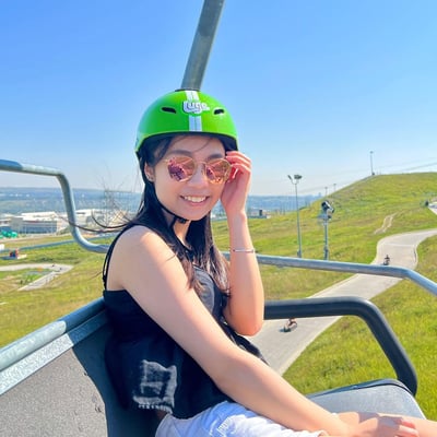 A woman poses for a photo on the Downhill Karting Calgary chairlift.