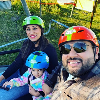 A family rides the Downhill Karting Calgary chairlift together.