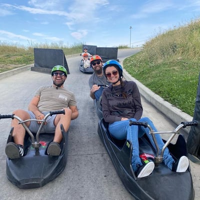 A group of friends pose for a photo on the Downhill Karting Calgary tracks.