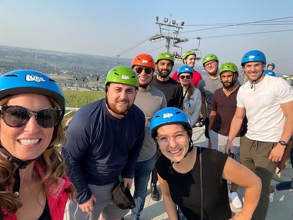 A group of friends pose for a photo at Downhill Karting Calgary.