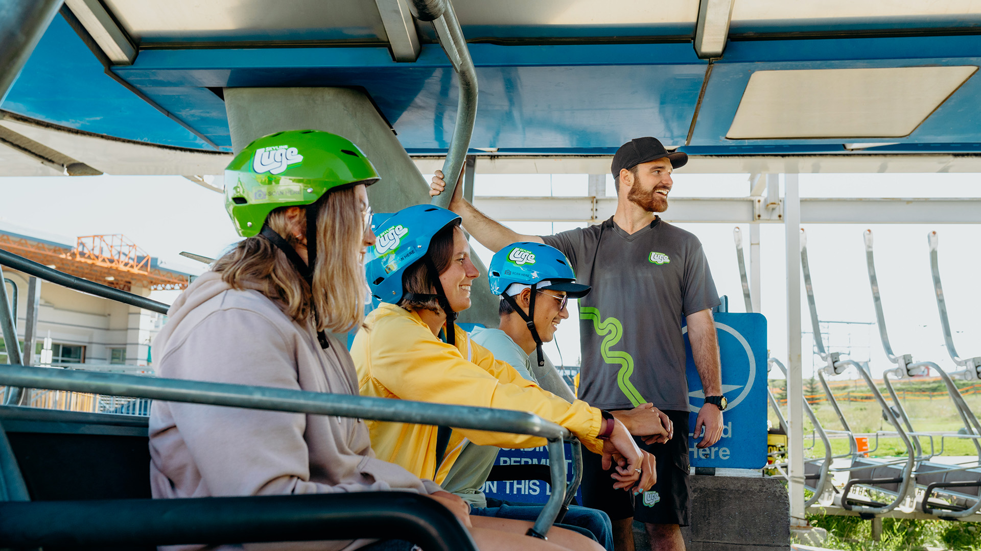 A group of friends ride the chairlift at Downhill Karting Calgary.