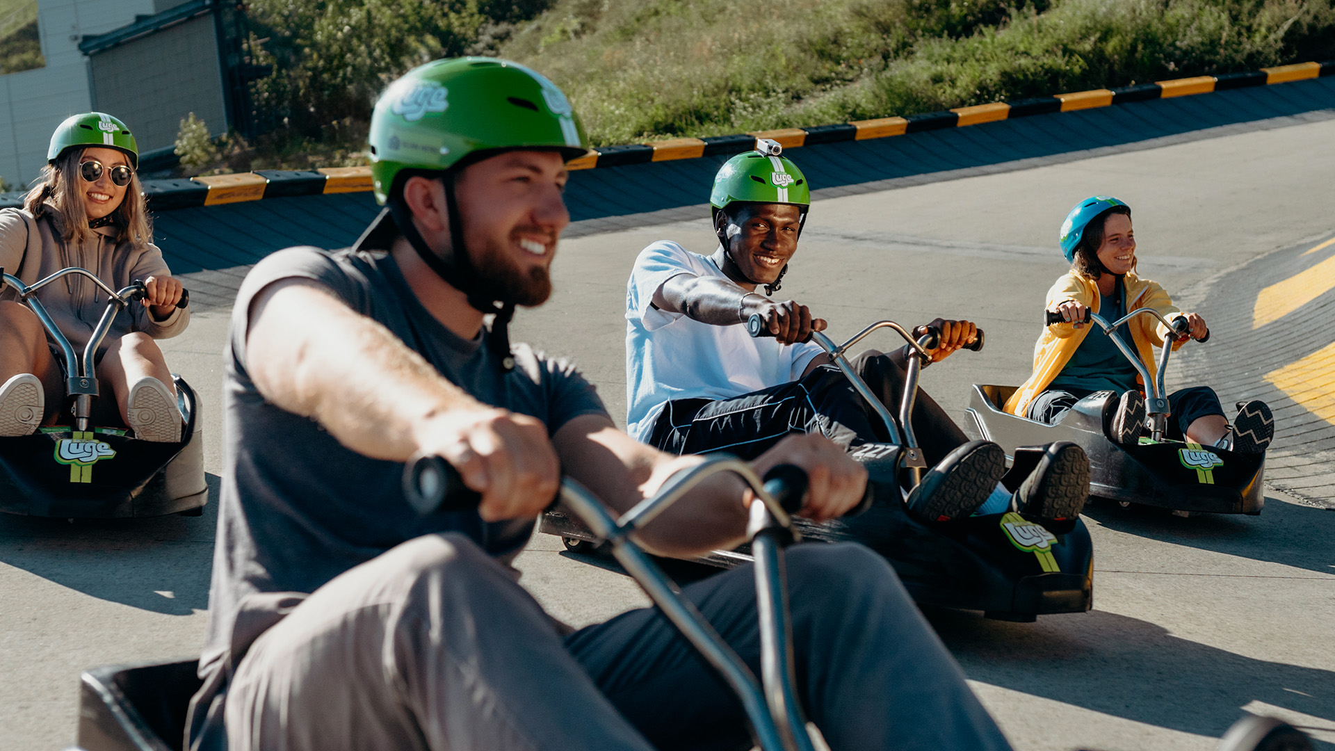 A group of friends race around a corner together at Downhill Karting Calgary.