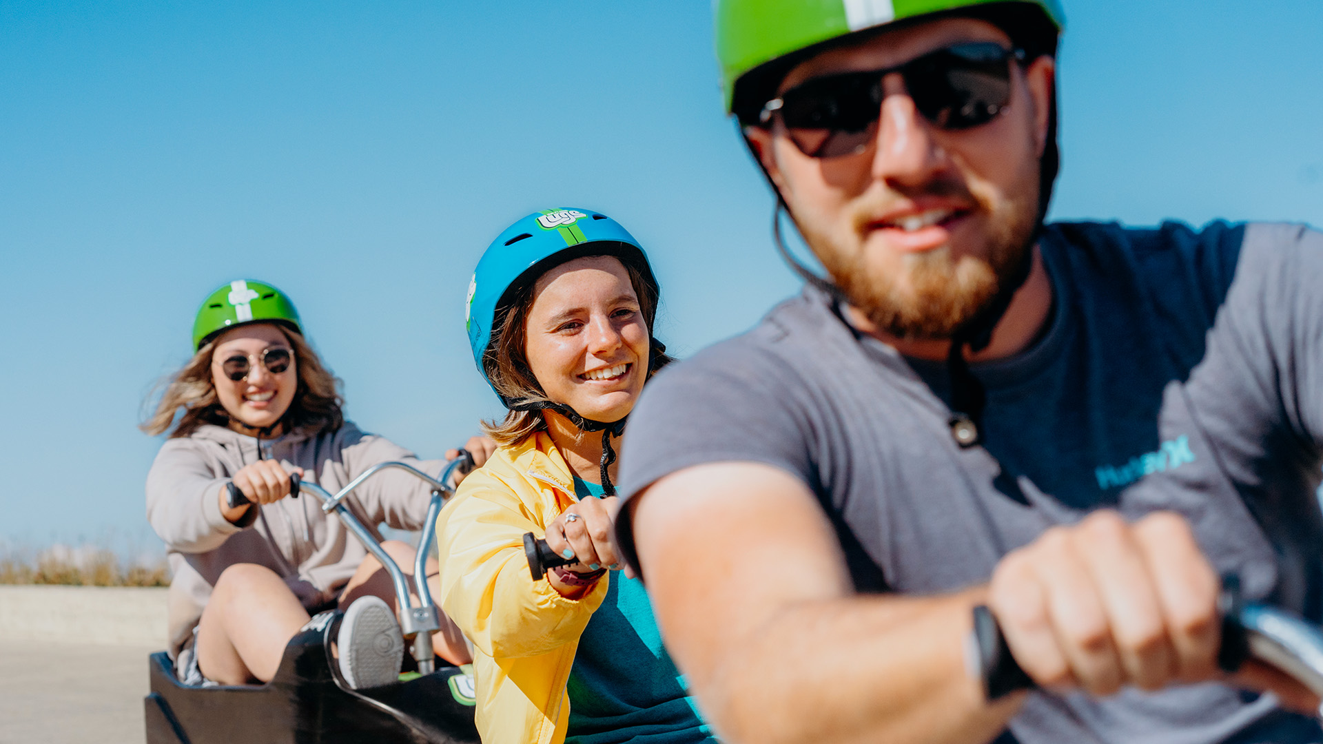 A man leads two friends down the tracks at Downhill Karting Calgary.