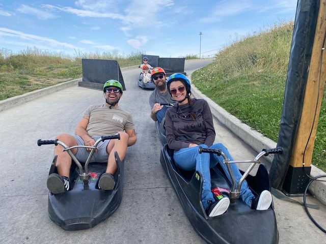 A group of friends pose for a photo on the Downhill Karting Calgary tracks.